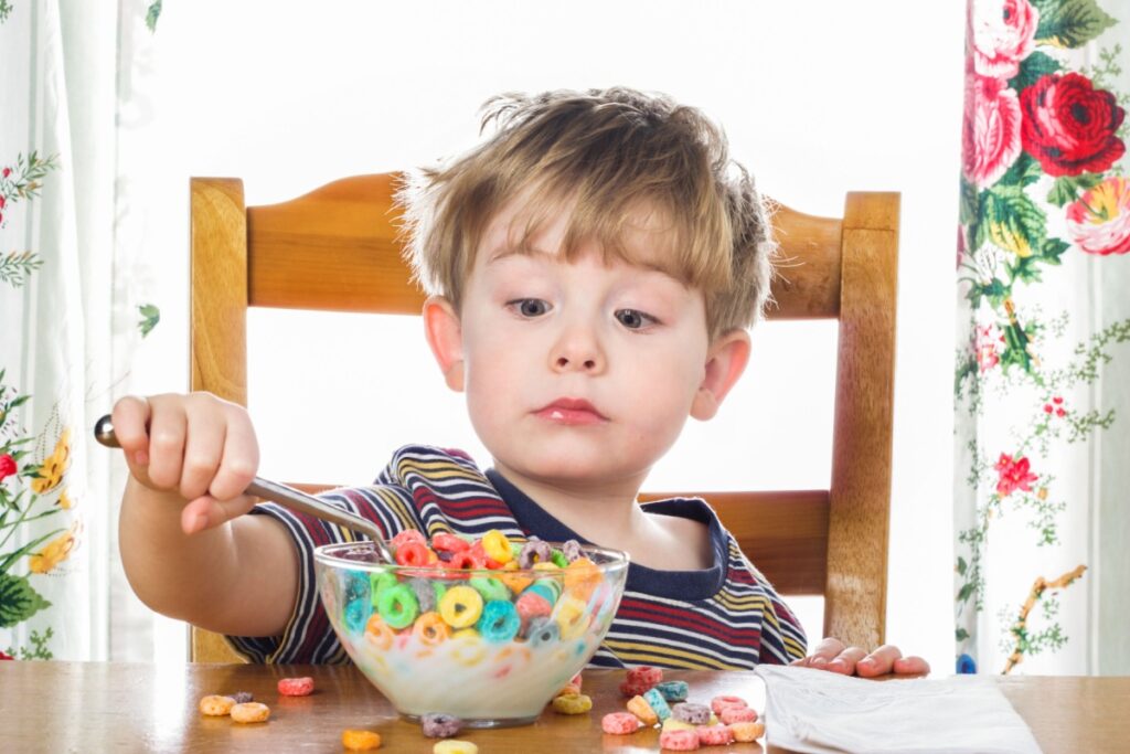 kid eating breakfast cereal Fruit Loops