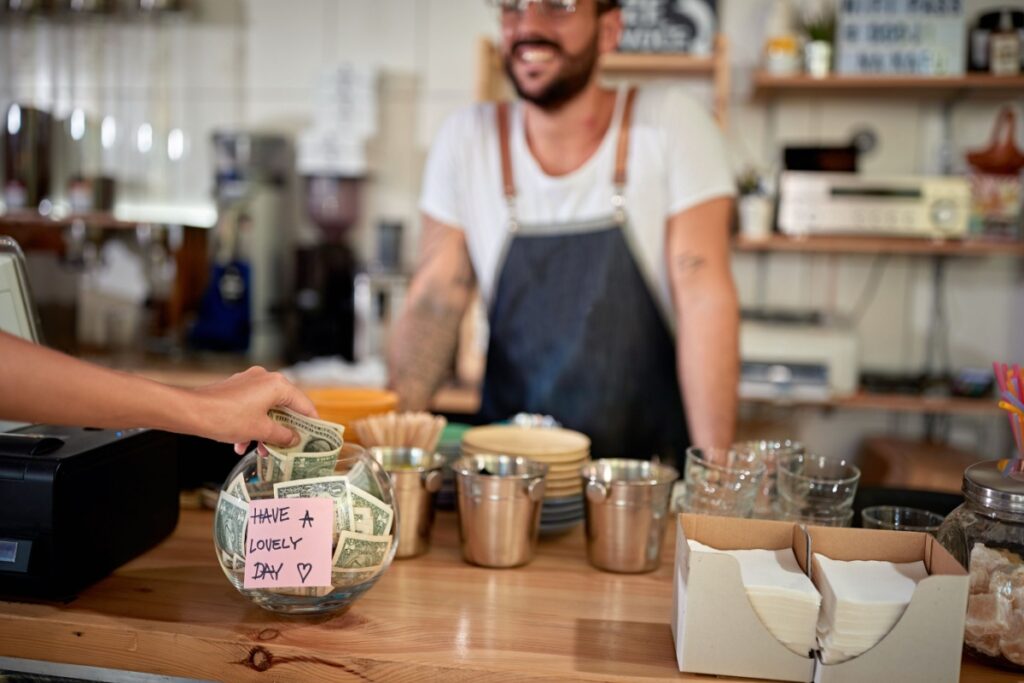 leaving tip in tip jar coffee shop