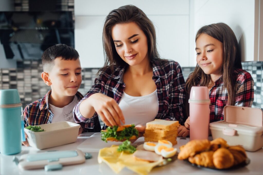 mom making sandwiches with kids