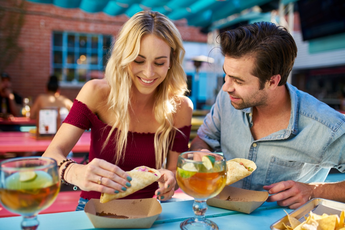 romantic couple eating street tacos