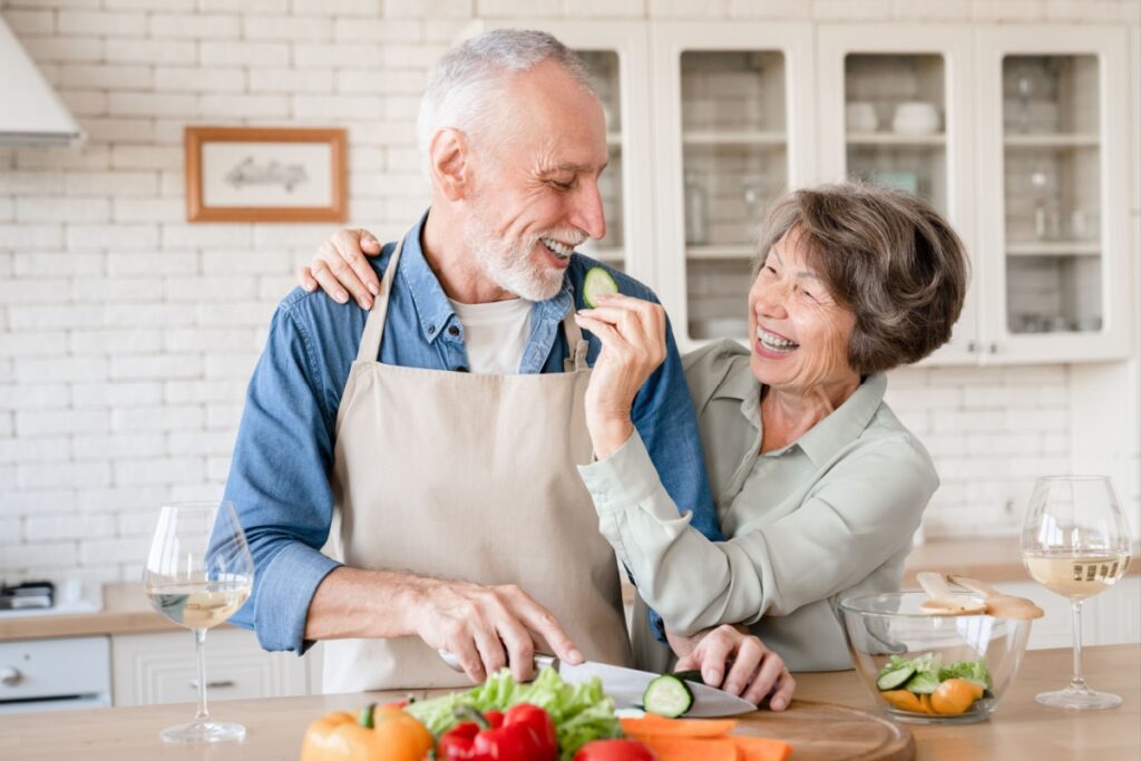 senior retired couple cooking in kitchen