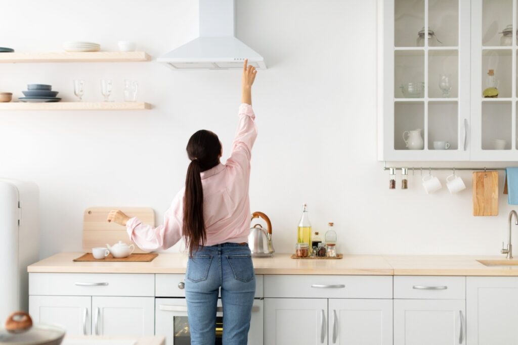 woman adjusting range ventilate