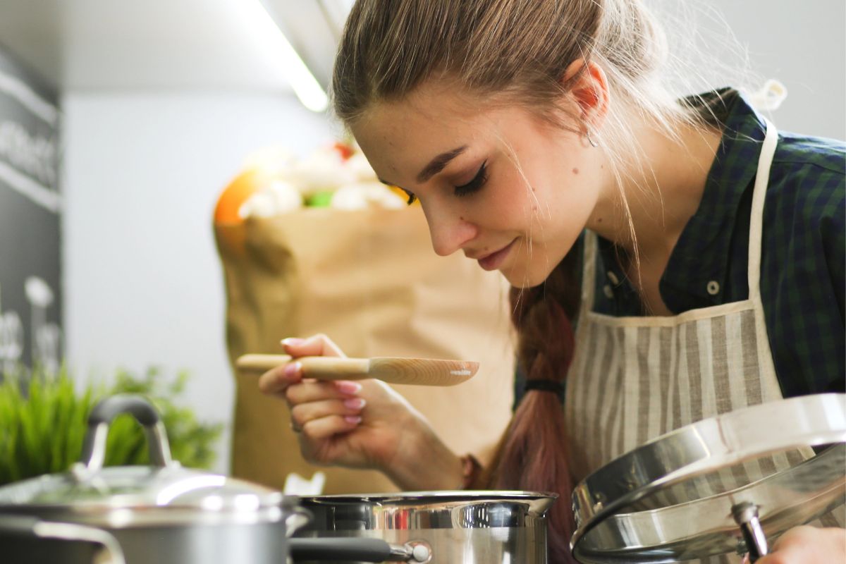 woman cooking over a stove