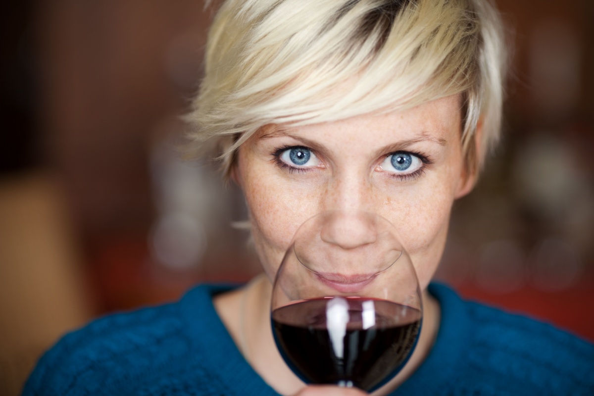 woman drinking red wine smiling