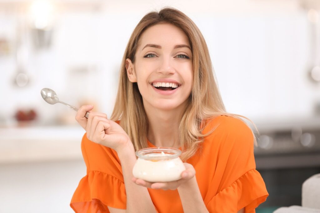 woman eating tasty yogurt