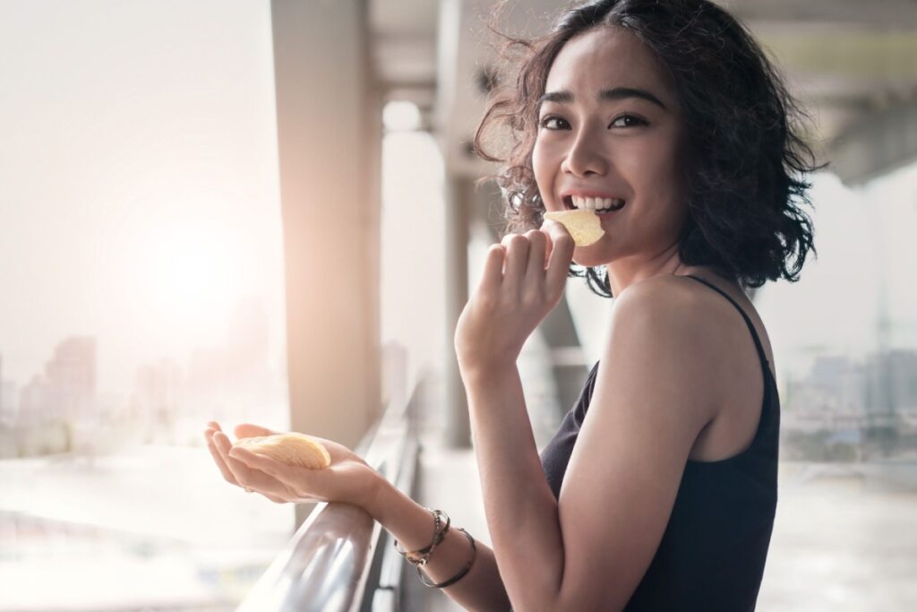 woman eating snack potato chips