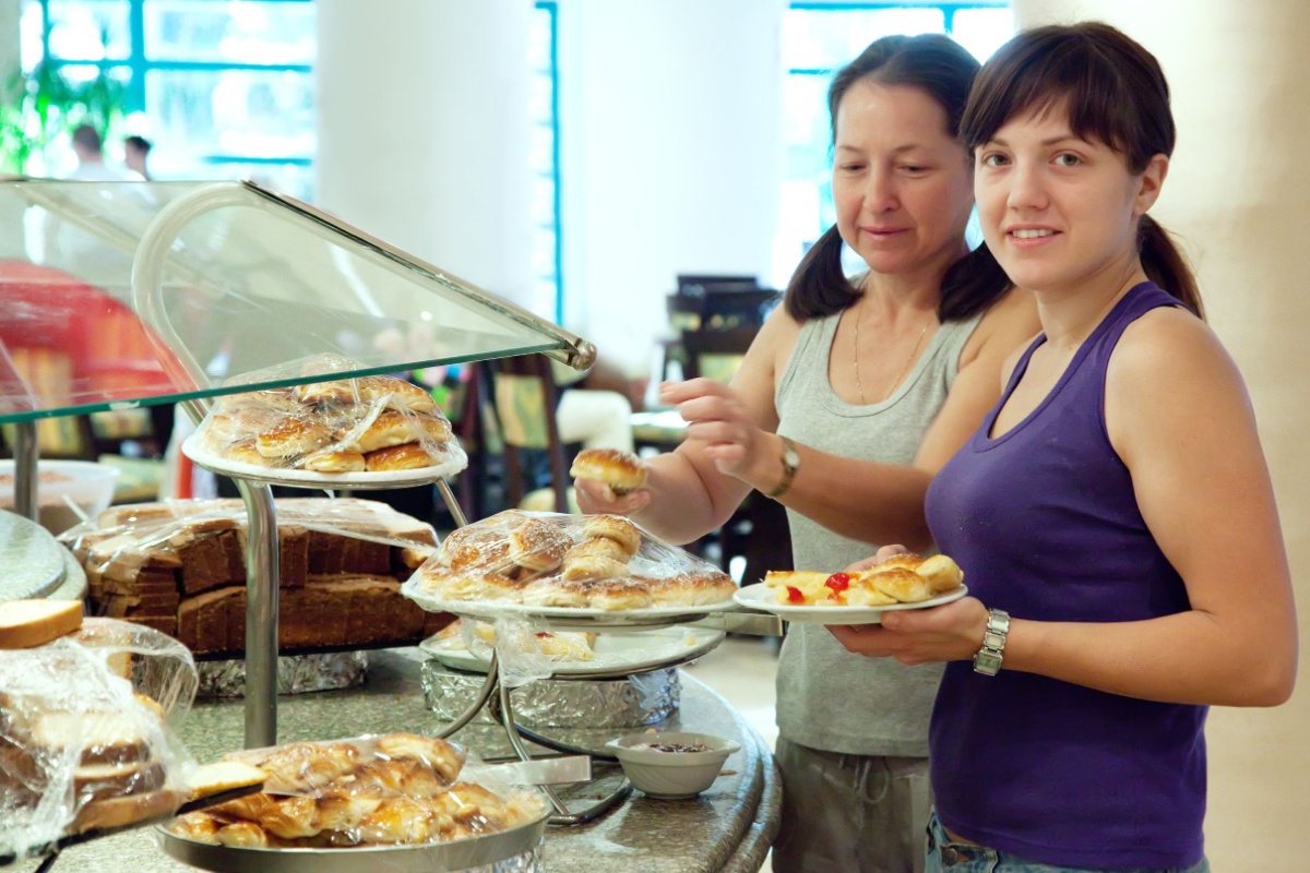 women taking pastries at buffet