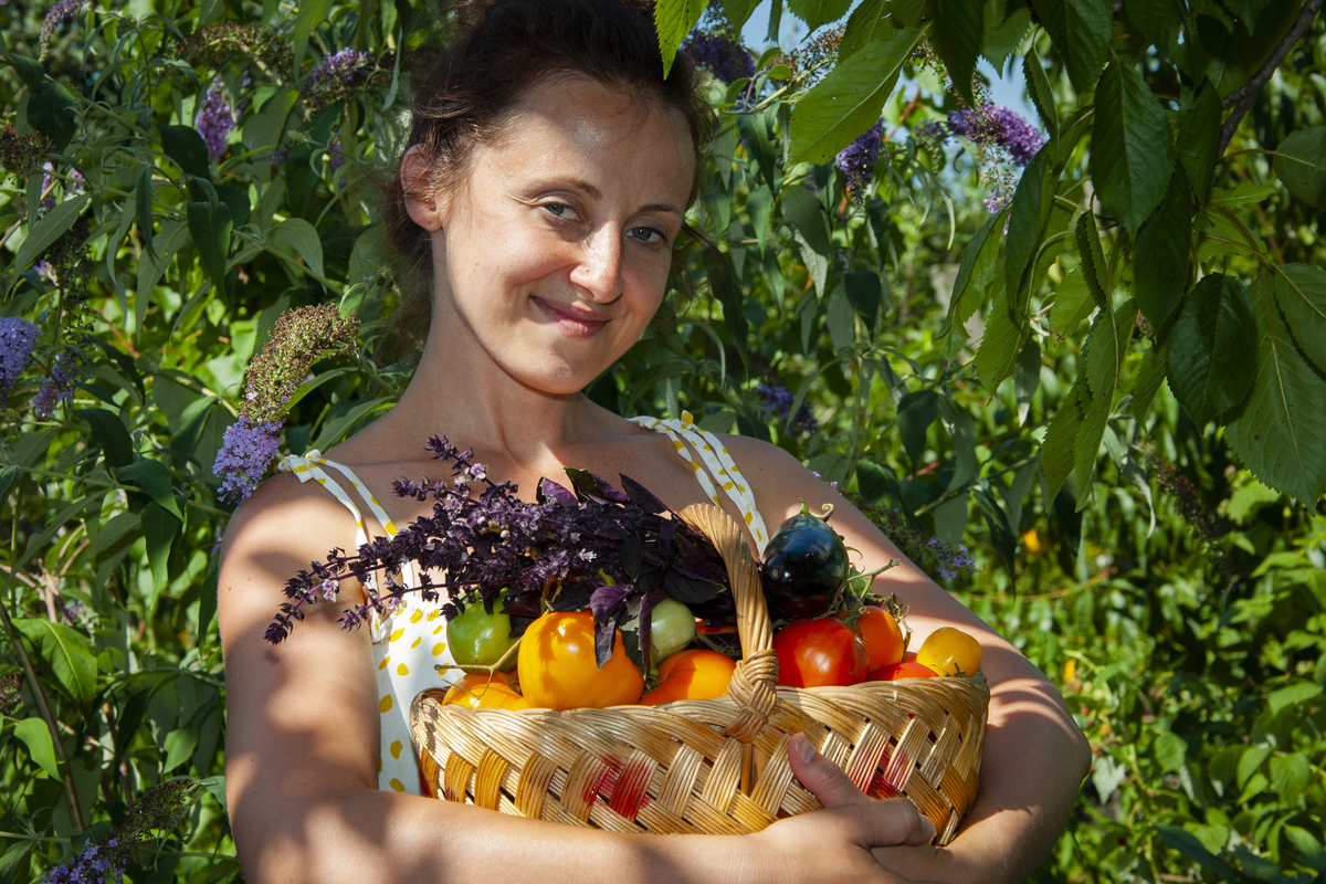 Woman farmer with vegetable harvest. organic food and eco farming.