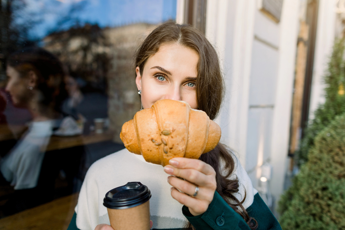 Young pretty stylish woman hiding half of her face