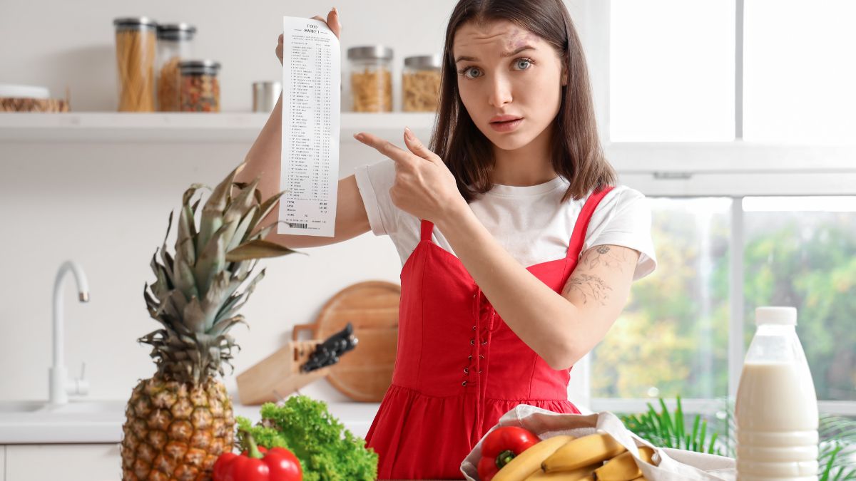 woman pointing to grocery receipt